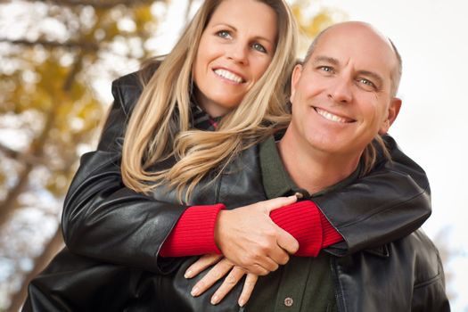 Happy, Attractive Couple in Park with Leather Jackets.