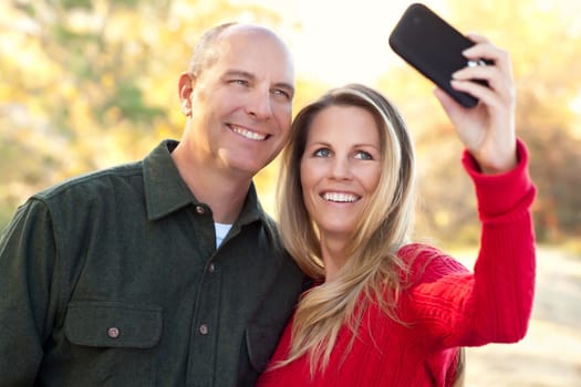 Happy, Attractive Couple Pose for a Self Portrait Outdoors.