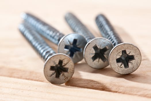 tools series: long screws on wooden table