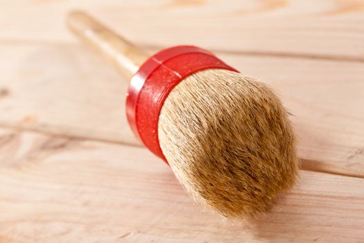 tools series: roud paint brush on wooden plank