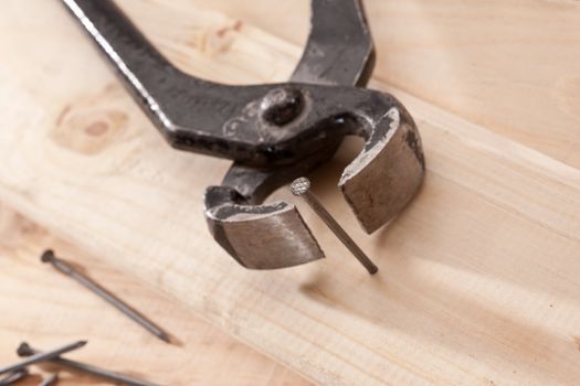 tools series: steel naildrawer and nail on wwoden plank