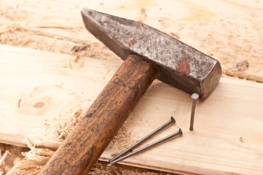 tools series: hammer and nails on the wooden plank