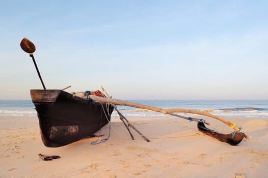 Wooden old fishing boat on the sandy shore