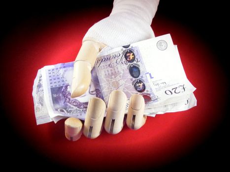 Wooden hand wrapped in bandages holding cash
