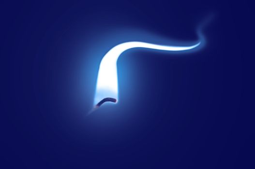 Close up on an ignited candle wick with extended blue flame against a blue background.