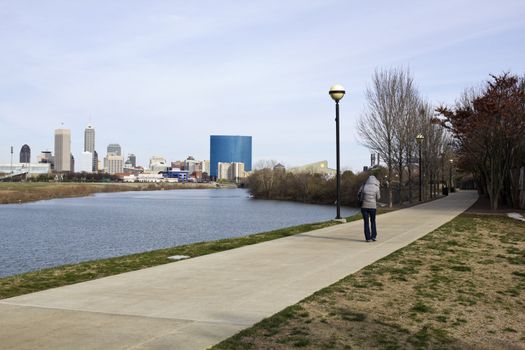 Spring morning in Indianapolis - girl walking the river trail.