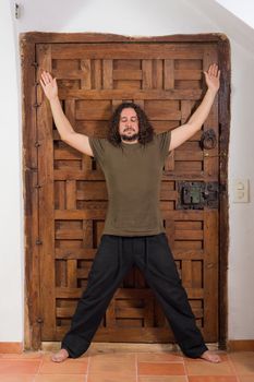 Long haired guy in contemplative attitude indoors