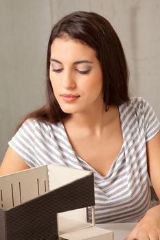 A female architect working on a rough house model