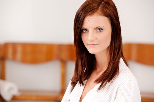 A portrait of a content woman in a spa looking at the camera