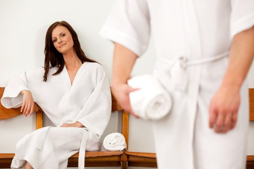 A coupld in a spa waiting room, shallow depth of field - focus on woman