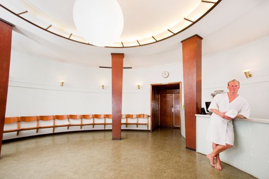 A fancy 20's styled Spa reception with male in bathrobe