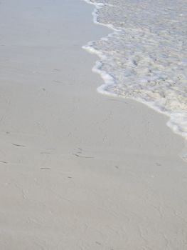 wave slowing coming up a sandy beach