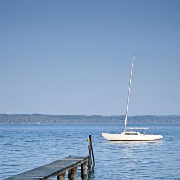 An image of a beautiful boat and jetty at Starnberg lake