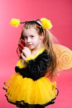 Pretty little girl dressed like a bee. Studio shot.