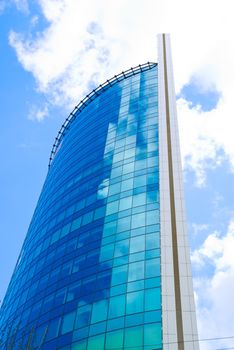 Blue sky and clouds behind the skyscraper