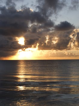 Sunrise over the ocean on a cloudy day