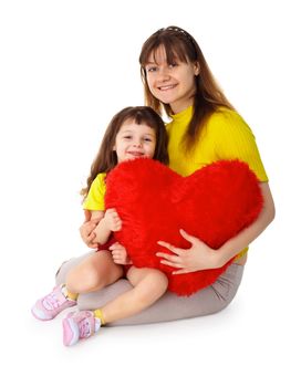 Mom and daughter sit with a toy heart in his hands isolated on white background