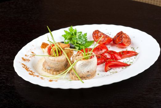 fillet of pikeperch stuffed with trout fish with baked pepper, tomato and leek