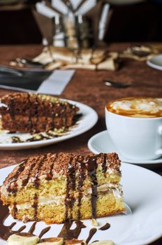 Dessert cakes with banana and coffee at table