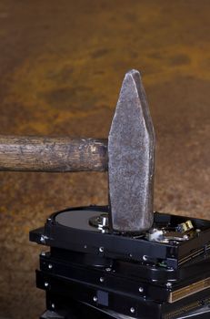 hammer on stack of hard disk in rusty background