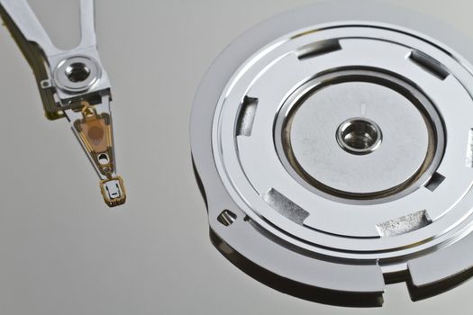 read write head in hard disk drive with platterand spindle in close up shot