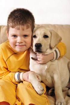 Cheerful little boy  with his puppy 
