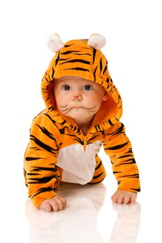 Six month baby wearing tiger suit sitting isolated on white