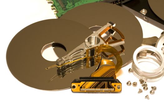 several parts of hard disk drives on light background