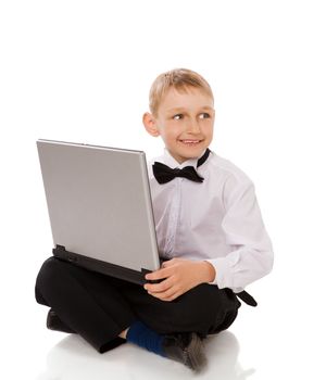 Six years Boy holding laptop isolated on white