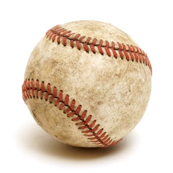 An isolated shot of a well used baseball.