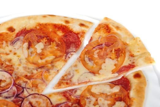 pizza closeup with salami, tomato, onion and mozzarella cheese