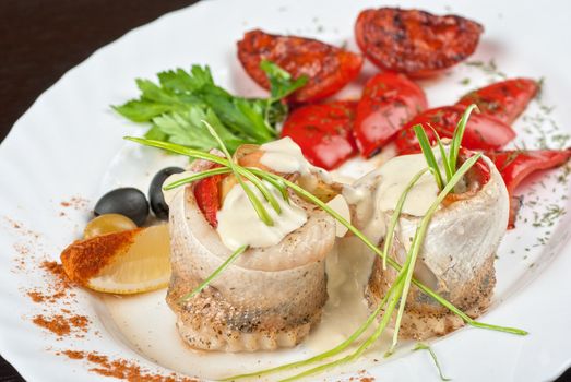 fillet of pikeperch stuffed with trout fish with baked pepper, tomato and leek