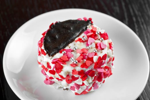 fresh baked cupcake with hearts on a wooden table