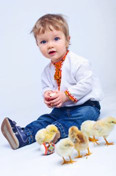 Cute little boy in embroidered with Easter eggs and easter chicks