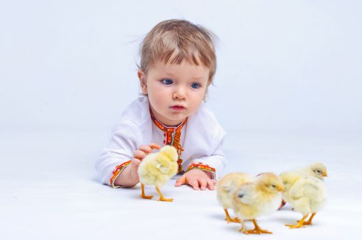 Cute little boy in embroidered with Easter eggs and easter chicks