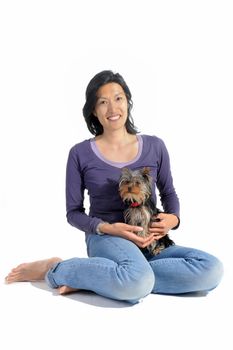 portrait of a purebred yorkshire terrier and asian girl in front of white background
