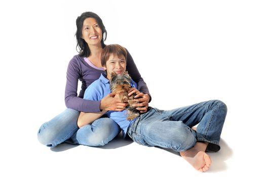 portrait of a purebred yorkshire terrier and asian family in front of white background
