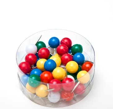 a bunch of pushpins in a box on white background
