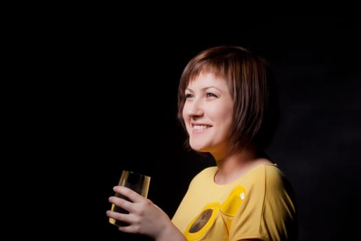 young woman with glass water, black background