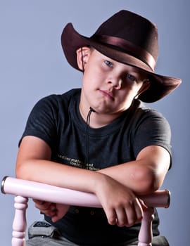 Young boy. Portrait in studio on a grey background.