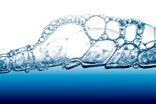 Air bubbles in blue water on white background.