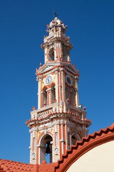 Baroque bell tower of Panormitis Monastery in Symi, a Dodecanese island, Greece.