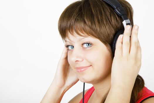 beautiful smiling girl teenager in the headphones
