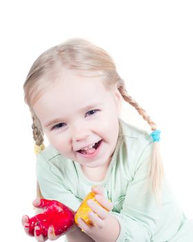 Studio shot of little girl playing with colors