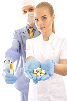 young doctor and his assistant  holding pills and syringe