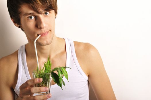 Portrait of man having grass cocktail symbolizing healthy food