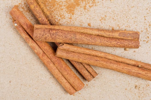 Cinnamon stick closeup on a brown background