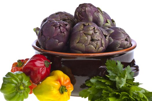 small exotic peppers and artichokes on a white background