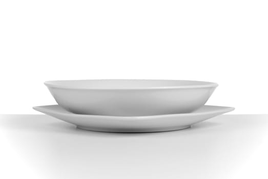Empty white ceramic soup dish on white background.