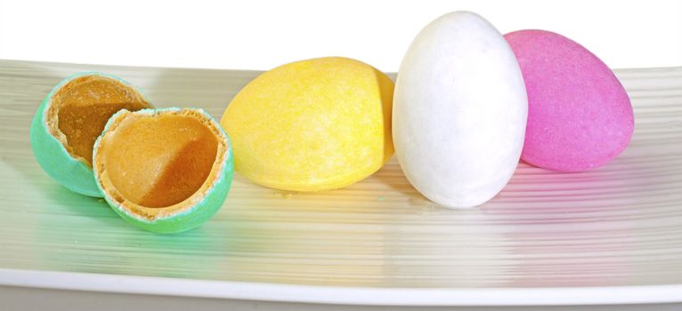 Sugar colored eggs over a white plate